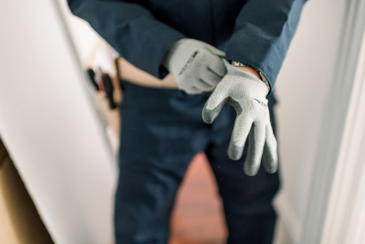 Contractor preparing for a remodeling project, wearing gloves and a work uniform, emphasizing professionalism and attention to detail in home improvement services.